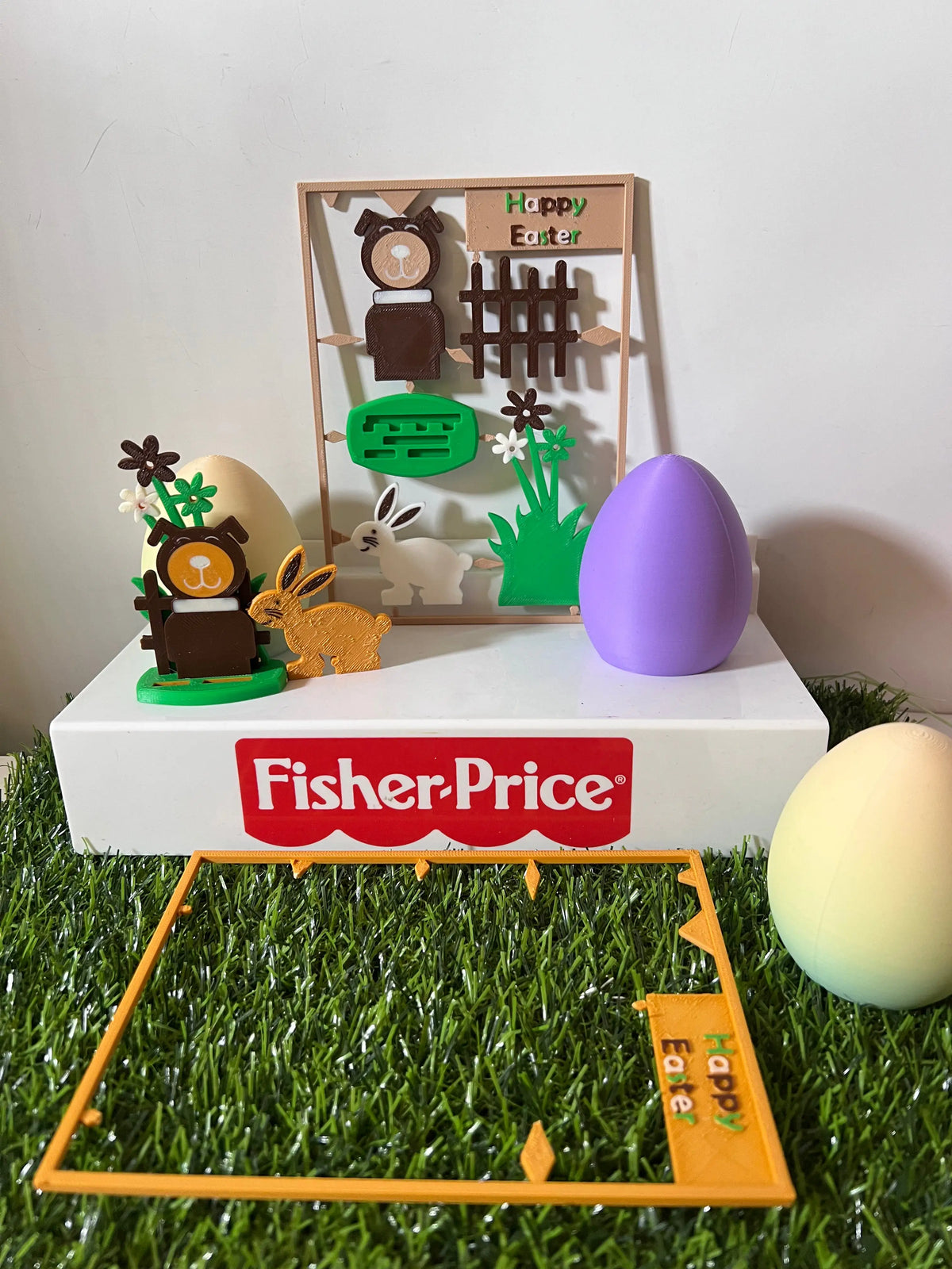 Easter wooden gift card on grass tray with Fisher-Price sign and colorful bunny stand