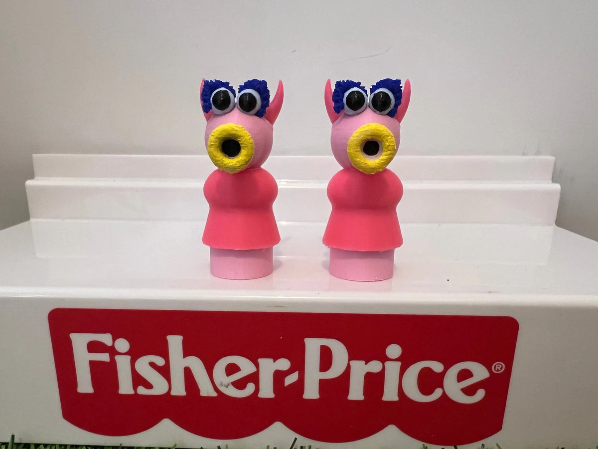 Pair of pink and gray muppet-style toy figurines with blue tuft hair and red outfits