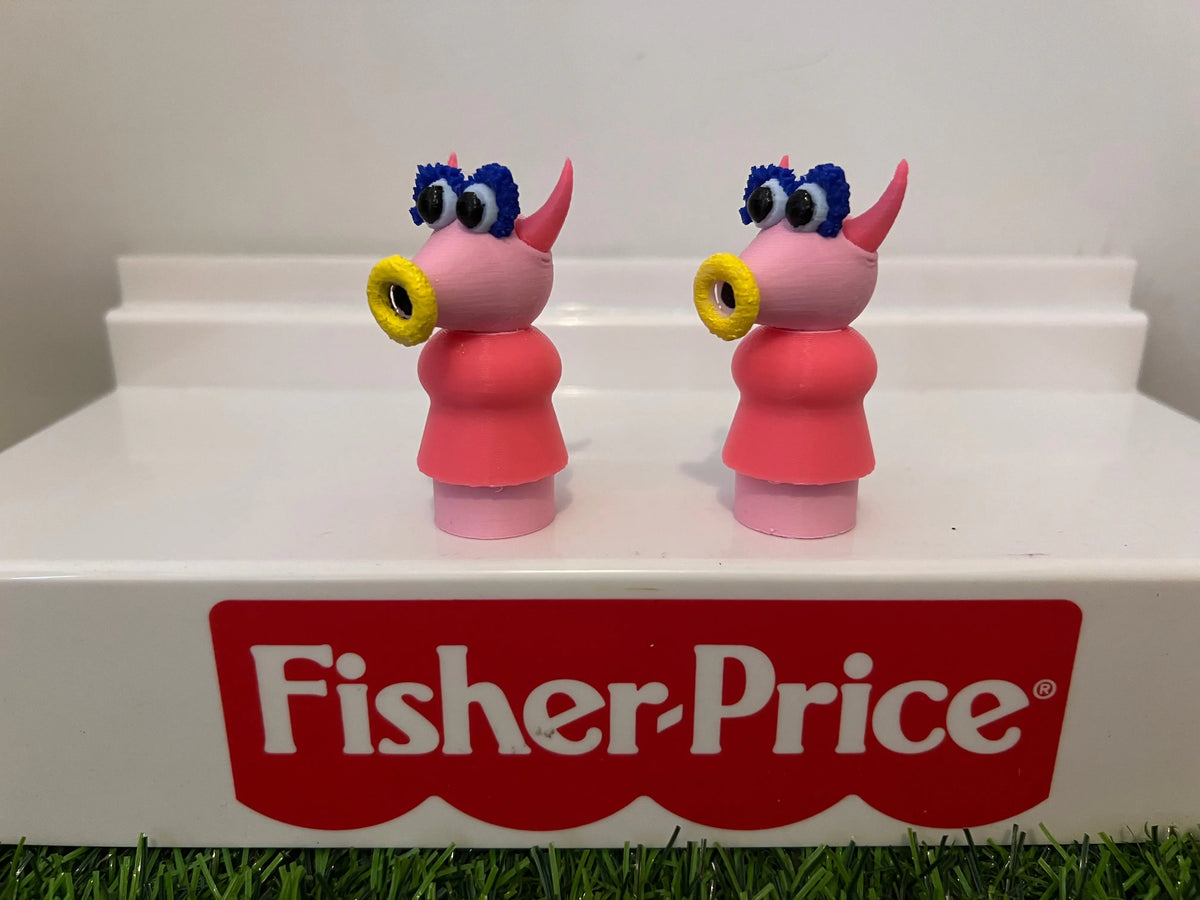 Pair of muppet-style toy figurines with blue hair, yellow ring eyes, and red outfit
