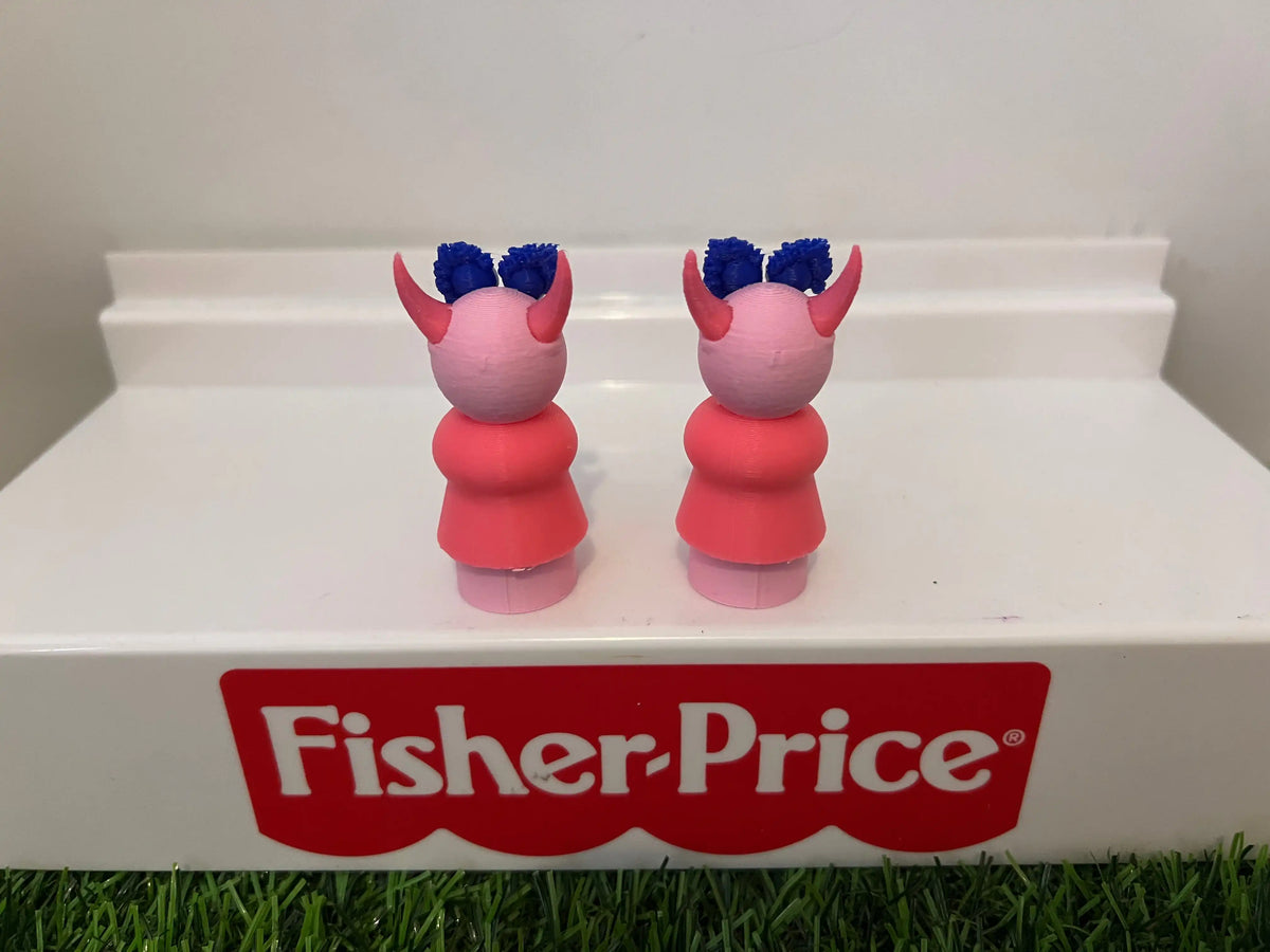 Two muppet-style toy figurines, back view with blue hair and red dress