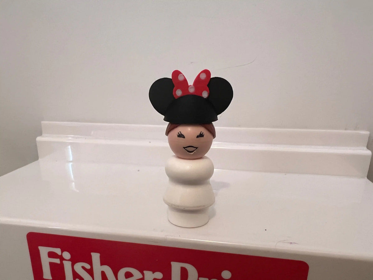Minnie-style mouse ear hat on smiling character figurine