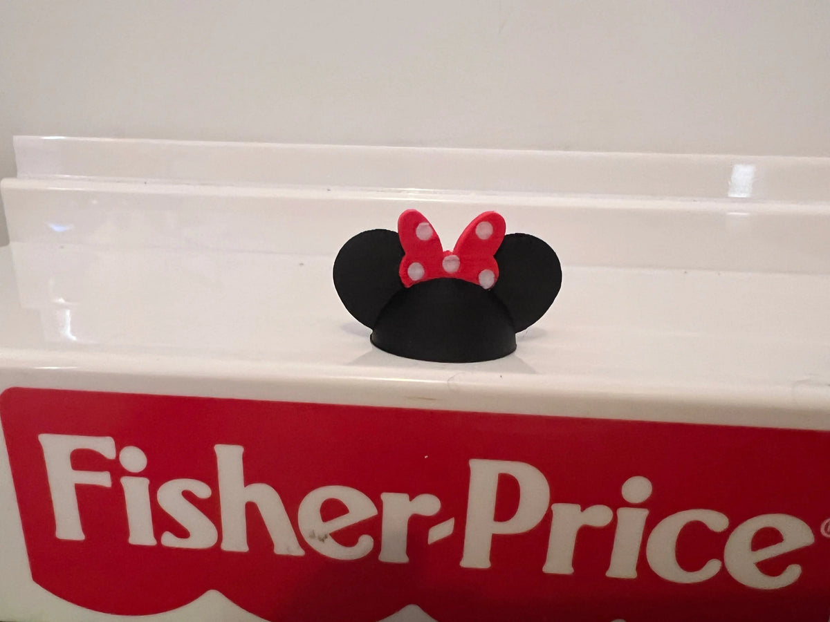 Black Minnie-style mouse ear hat with red bow headband