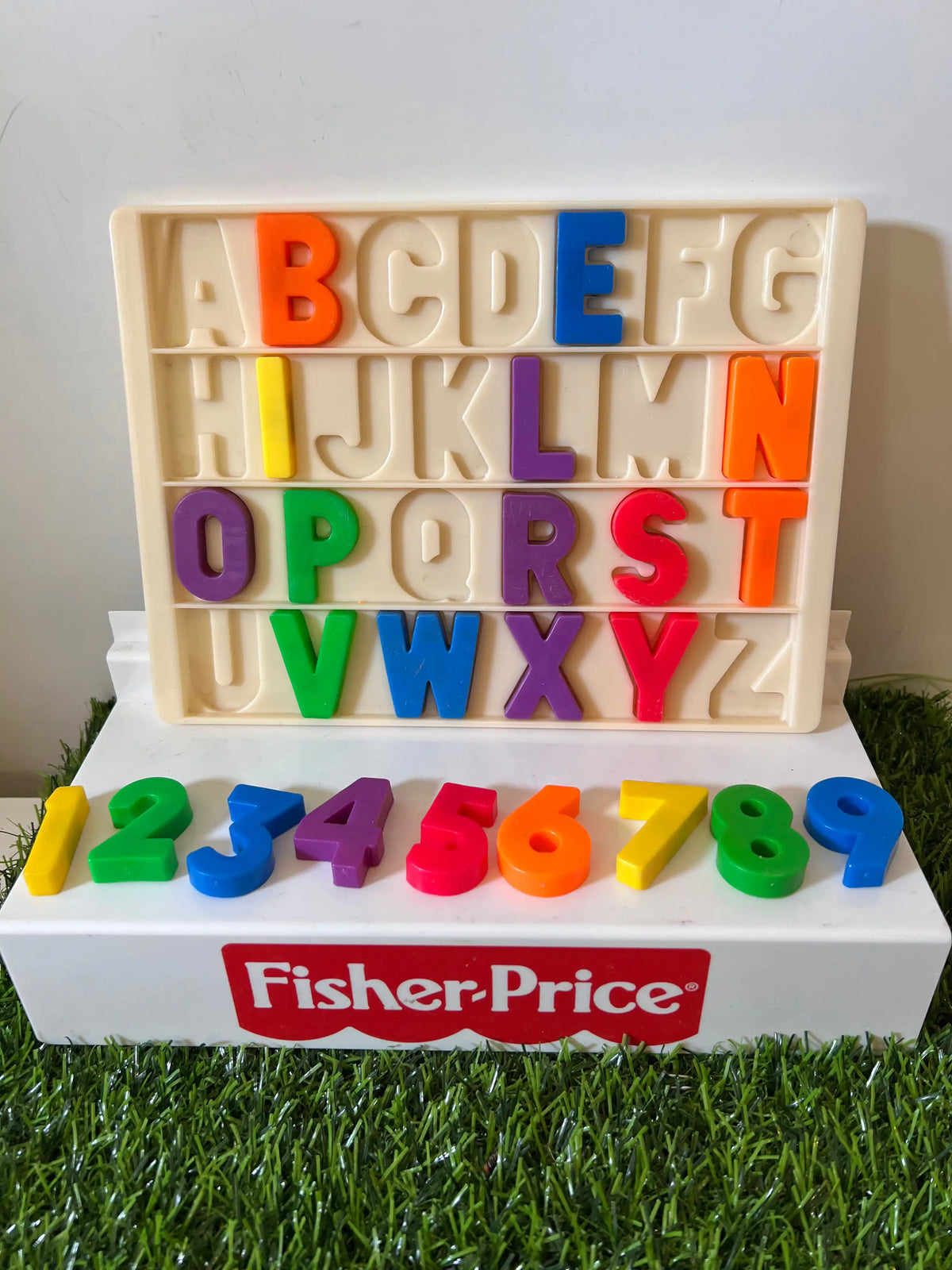 Beige letter tray with colorful A–Z tiles and Fisher-Price logo