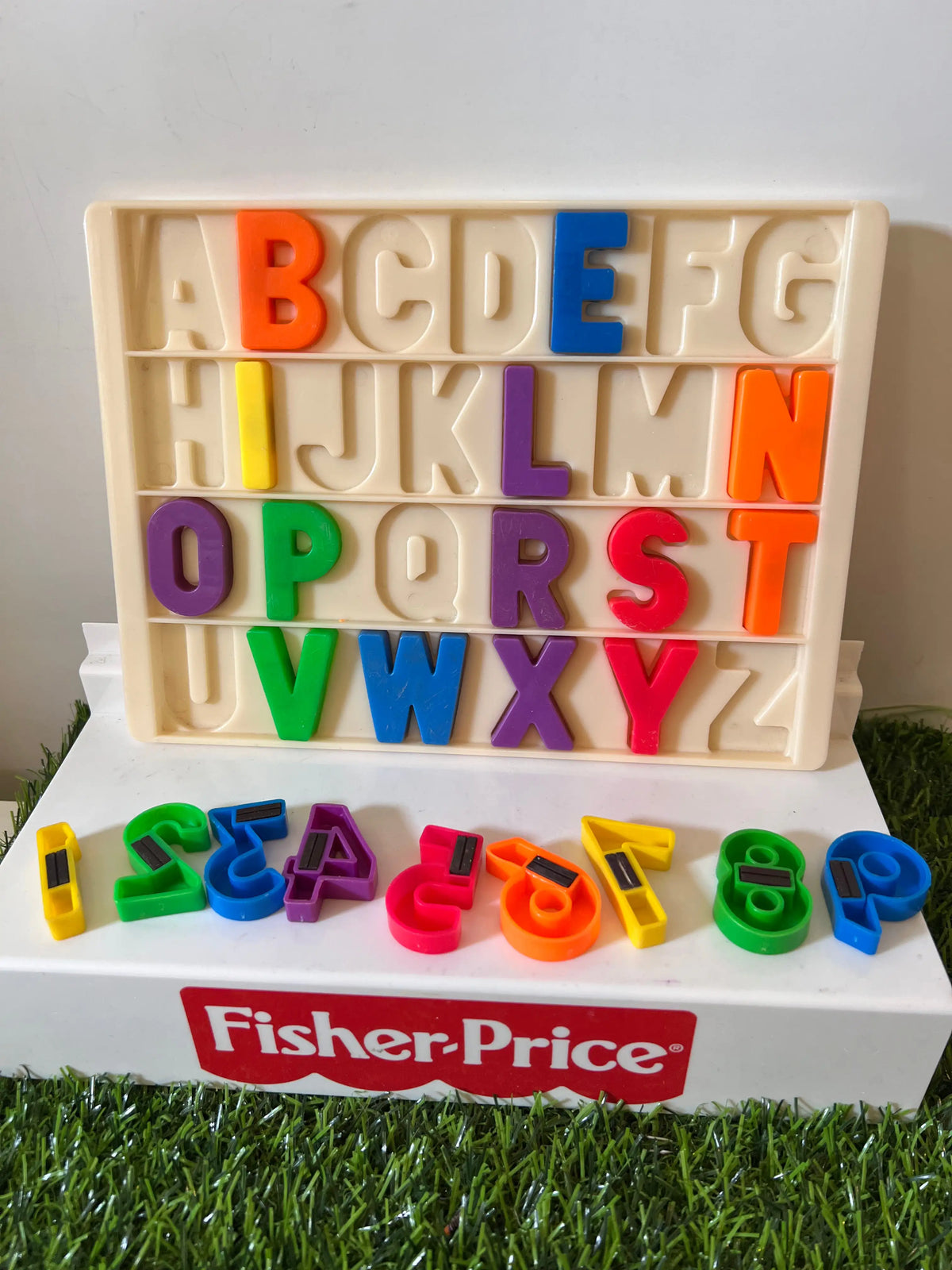 Beige letter tray with colorful A–Z tiles and Fisher-Price base