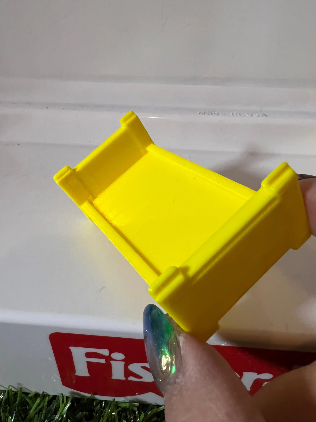 Yellow plastic bunk bed frame replacement with top guard rails, hand pointing