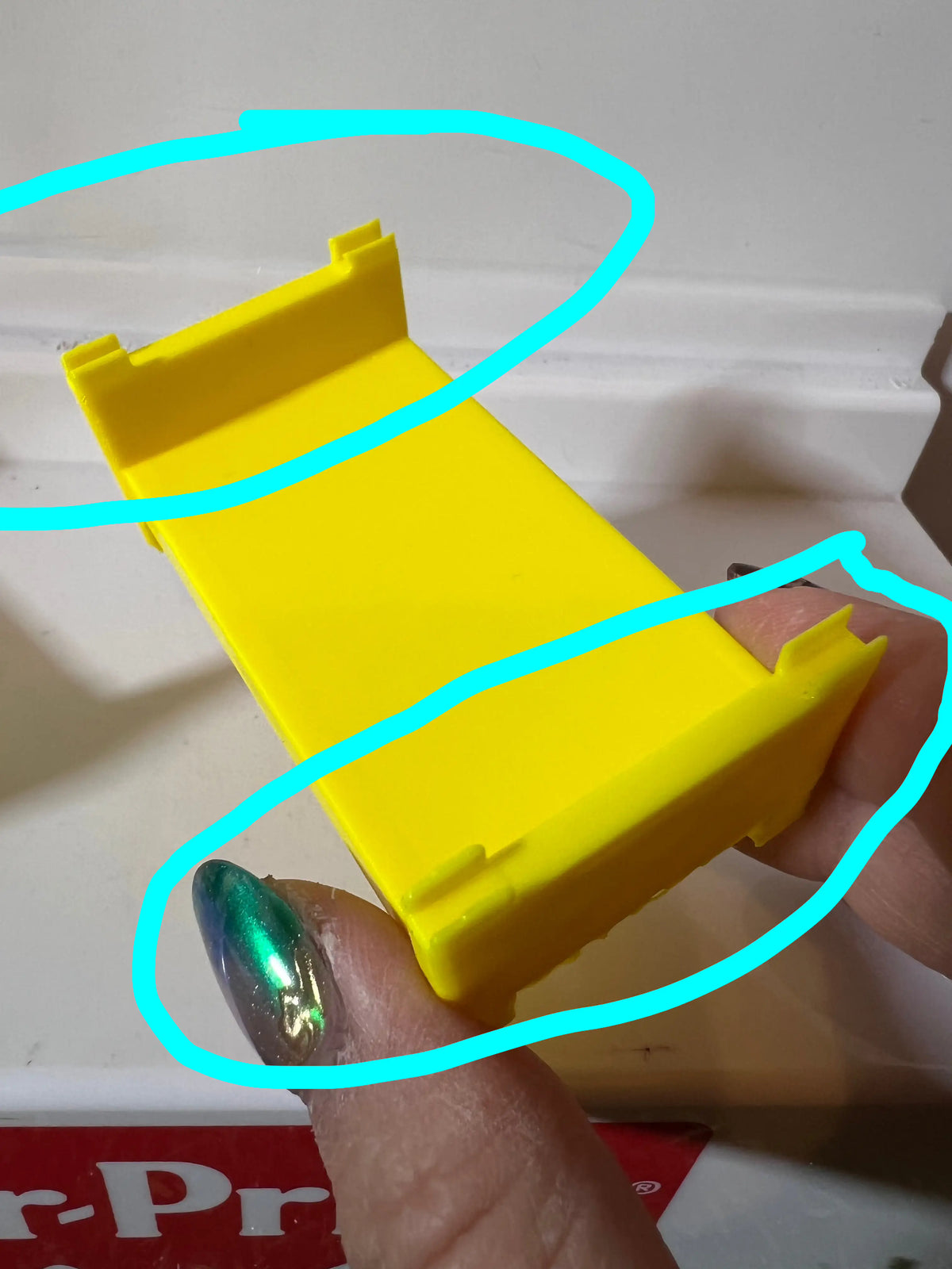 Yellow plastic bunk bed frame replacement with side guard rail detail, hand holding