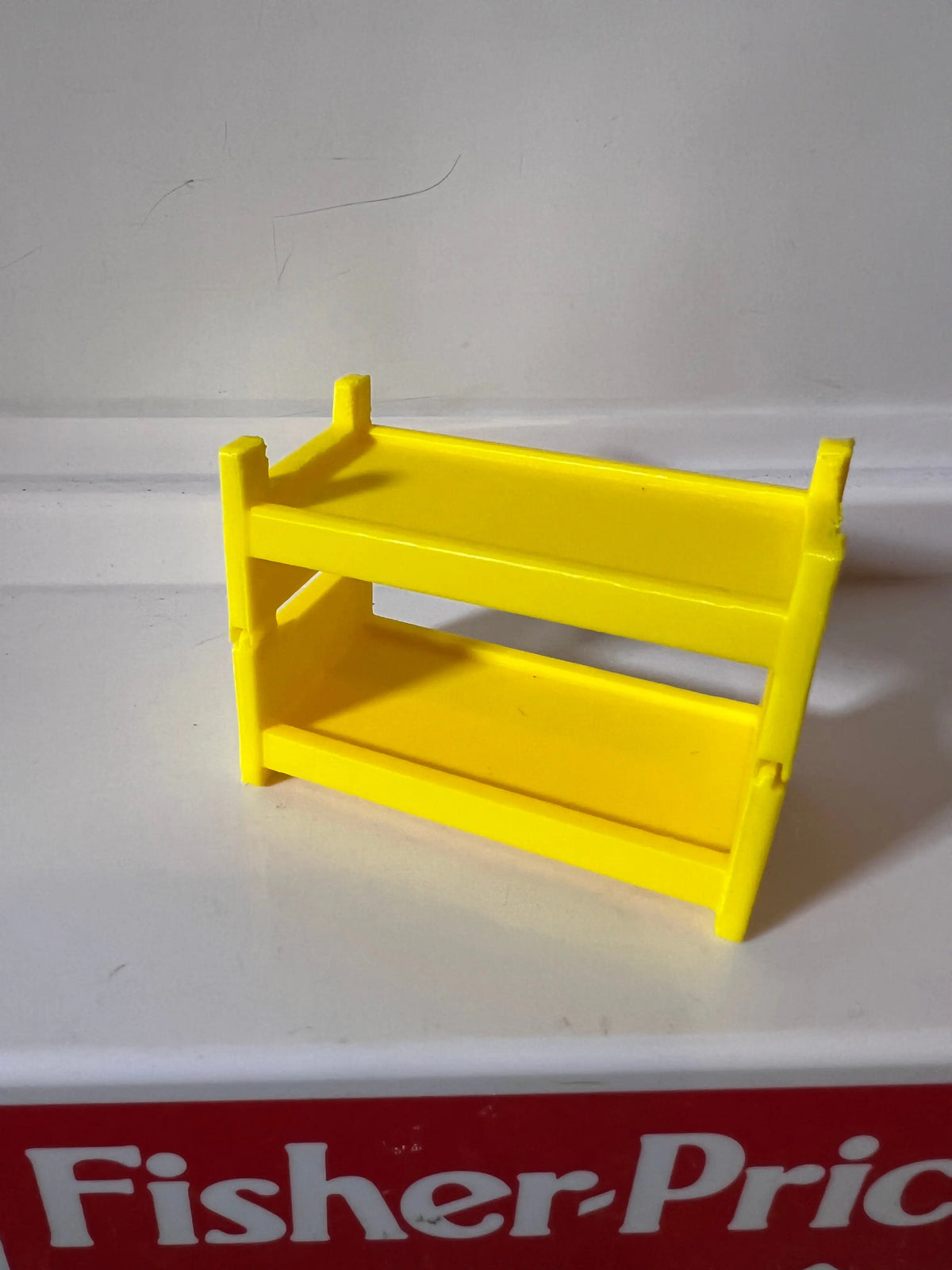 Yellow plastic bunk bed frame replacement with front guard rails, side view