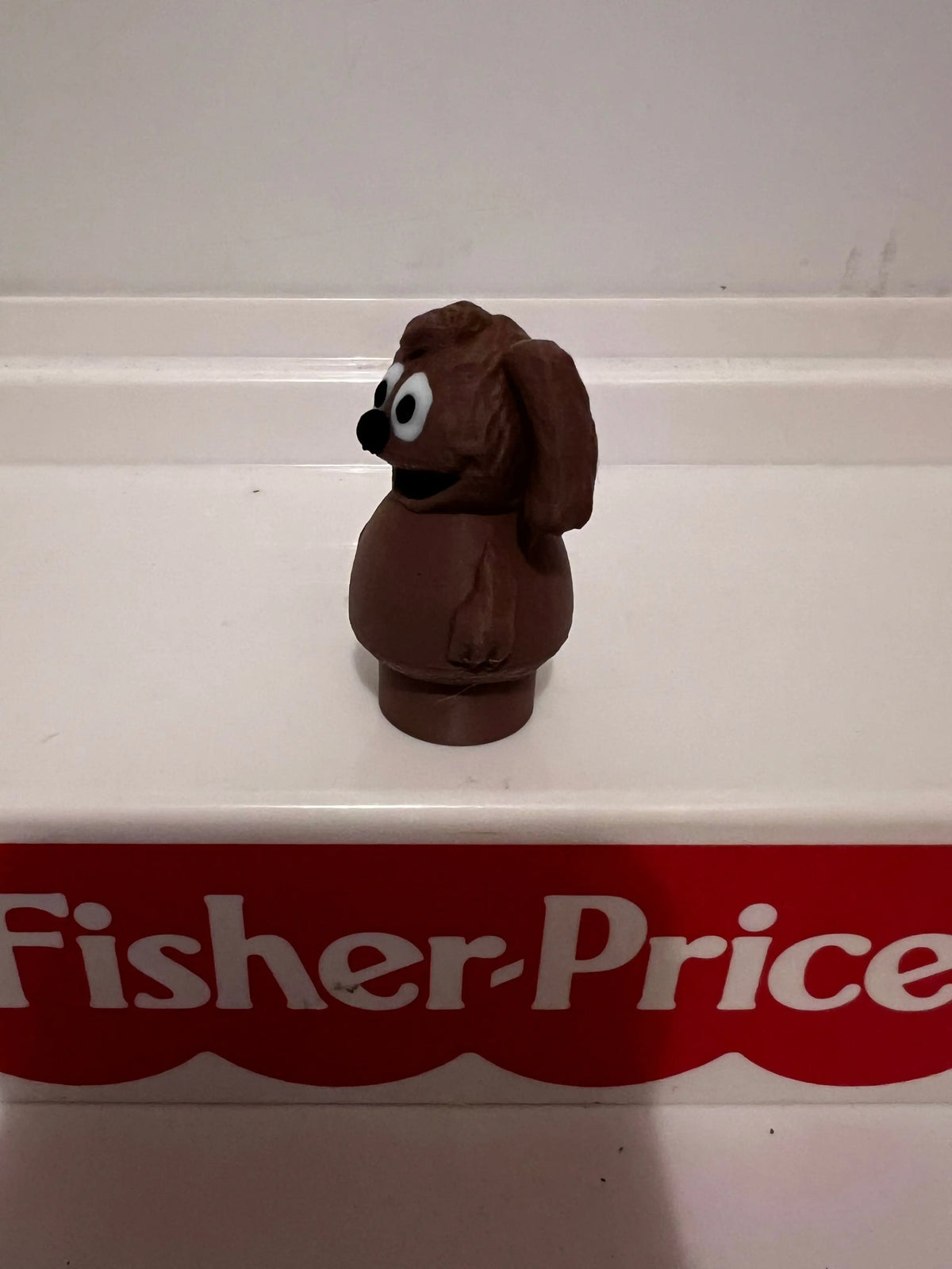 Rowlf plush dog figurine, brown with black nose and large white eyes, sitting