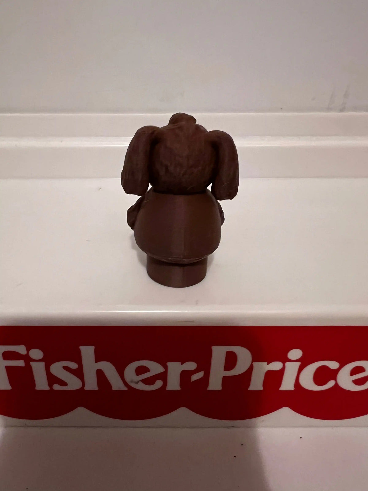 Rowlf plush dog figurine, brown back view with floppy ears and seated body