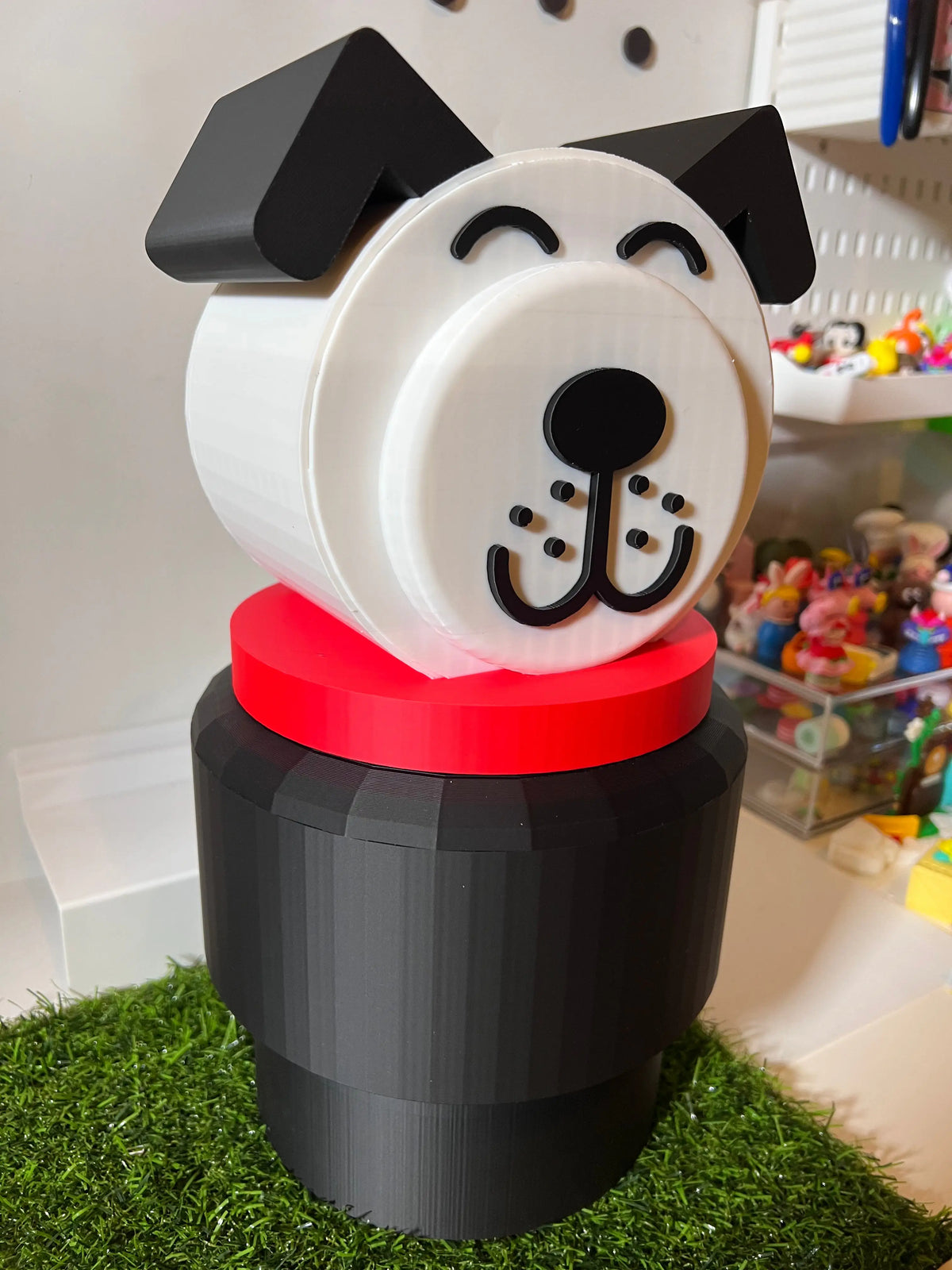 Jumbo dog stacking toy with white face and black ears, red collar, dark base