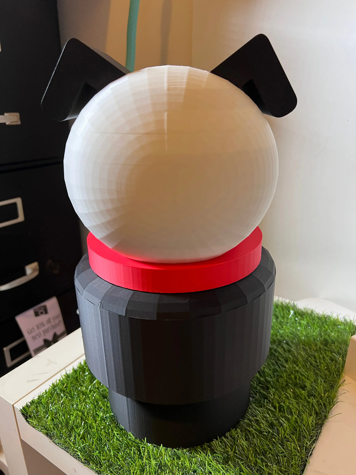 Jumbo dog stacking toy with cream round top, black ears, red collar, dark base