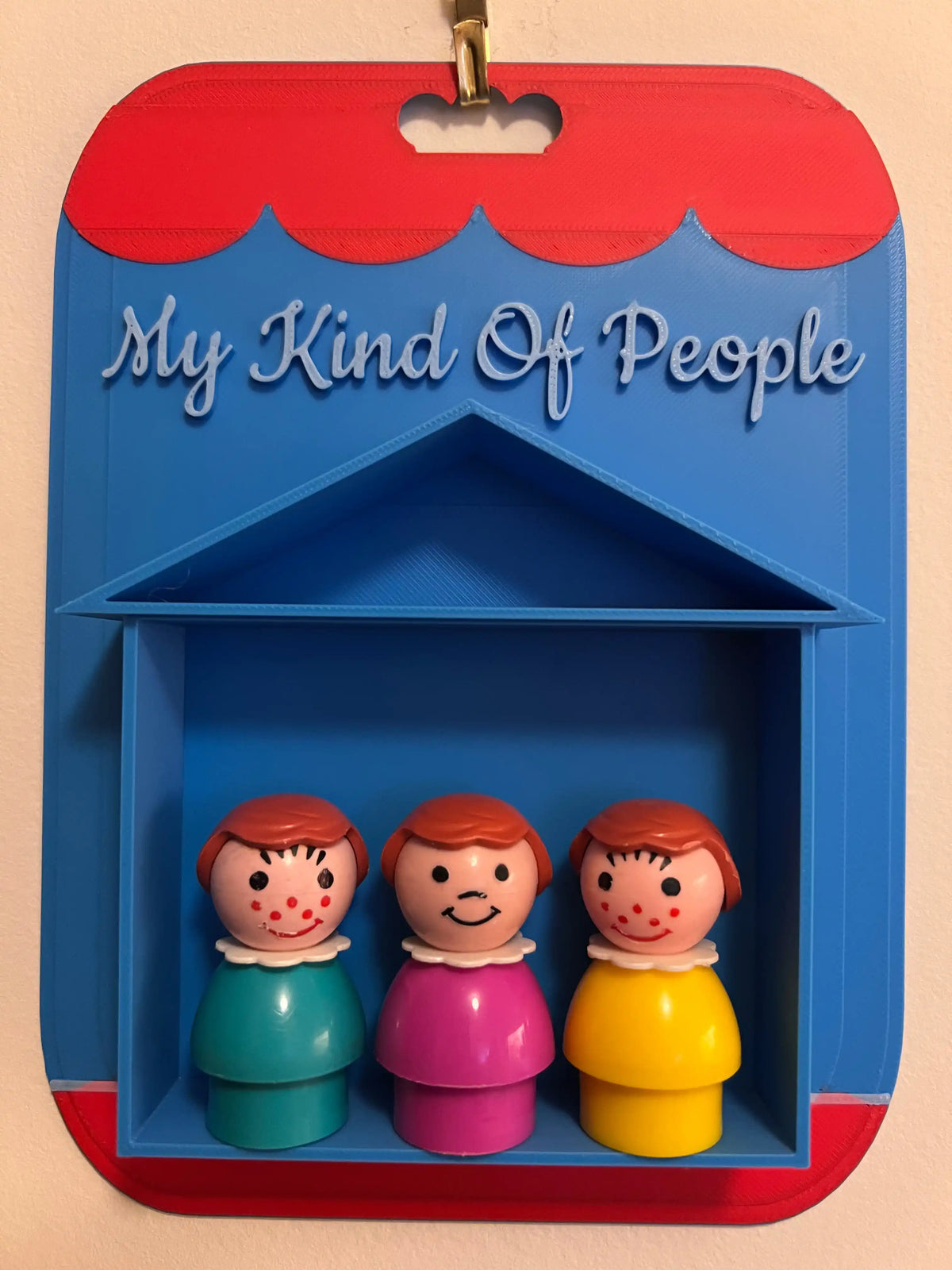 Red and blue display card reading “My Kind Of People” with three figurines