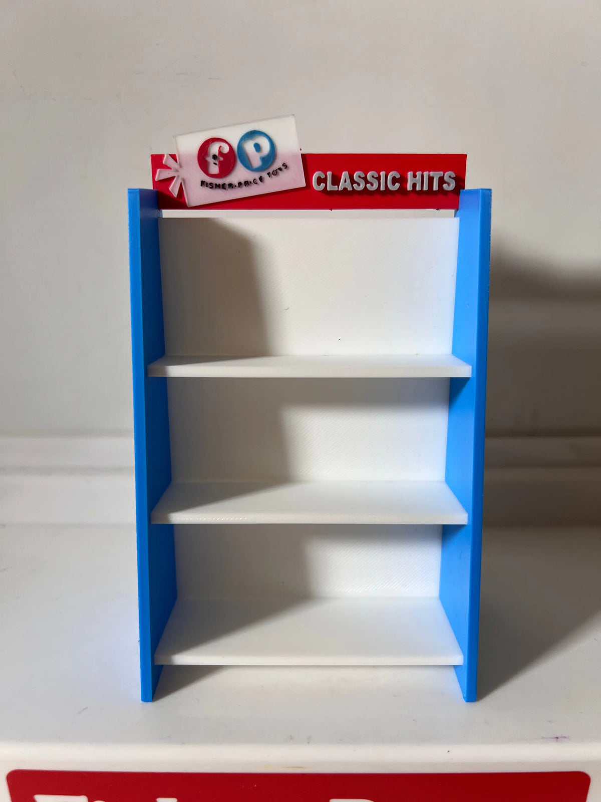 A custom Fisher-Price Little People toy shelf, blue and white, with "CLASSIC HITS" on top.