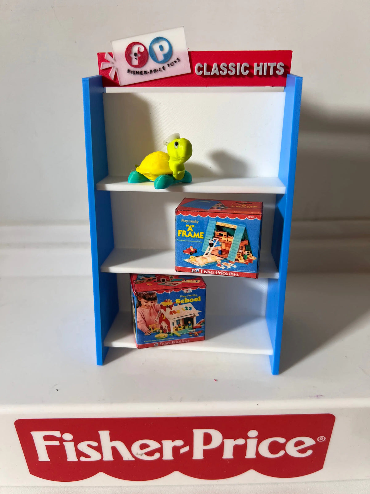 Fisher-Price toy shelf with blue frame, white shelves, and Classic Hits display