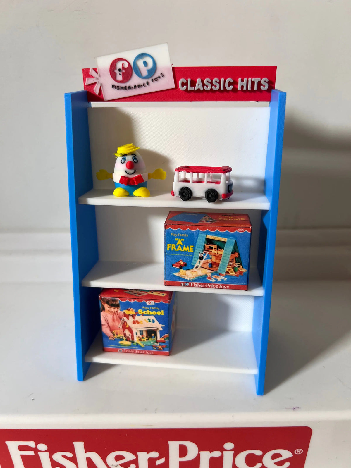 Fisher-Price toy shelf with blue frame, white shelves, and figures with boxes