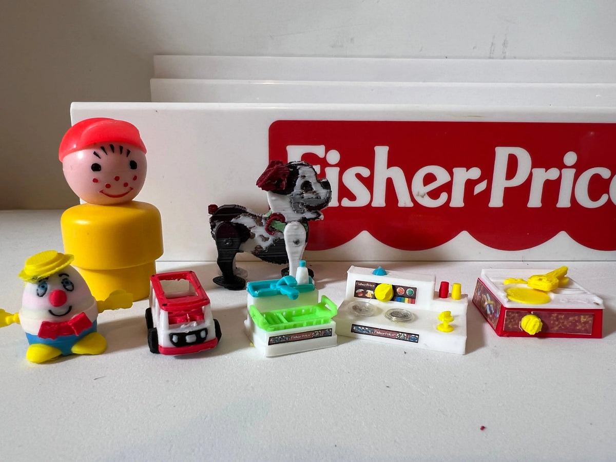Miniature Fisher-Price puppy figurine with red bow, with toy accessories nearby