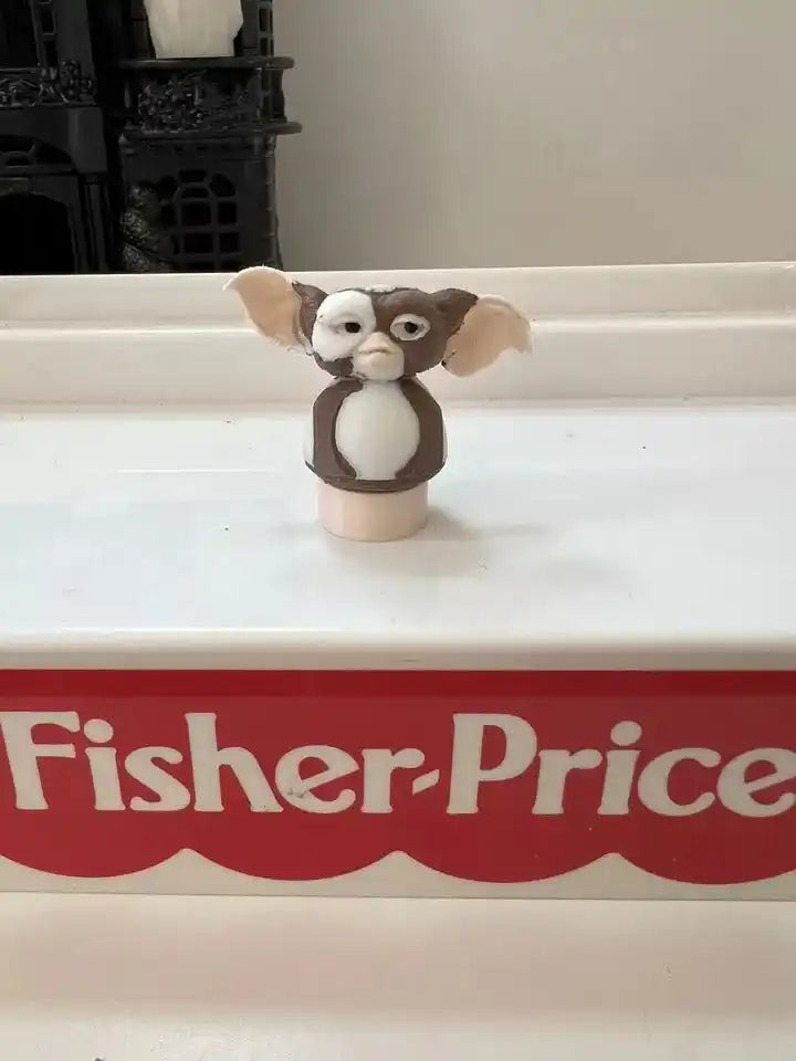 Centered brown-and-white dog figurine with raised ears on round beige base
