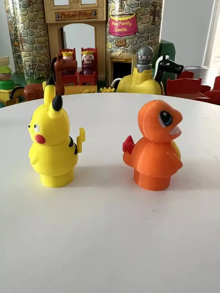 Yellow Pikachu figure facing left and orange lizard figure with raised tail