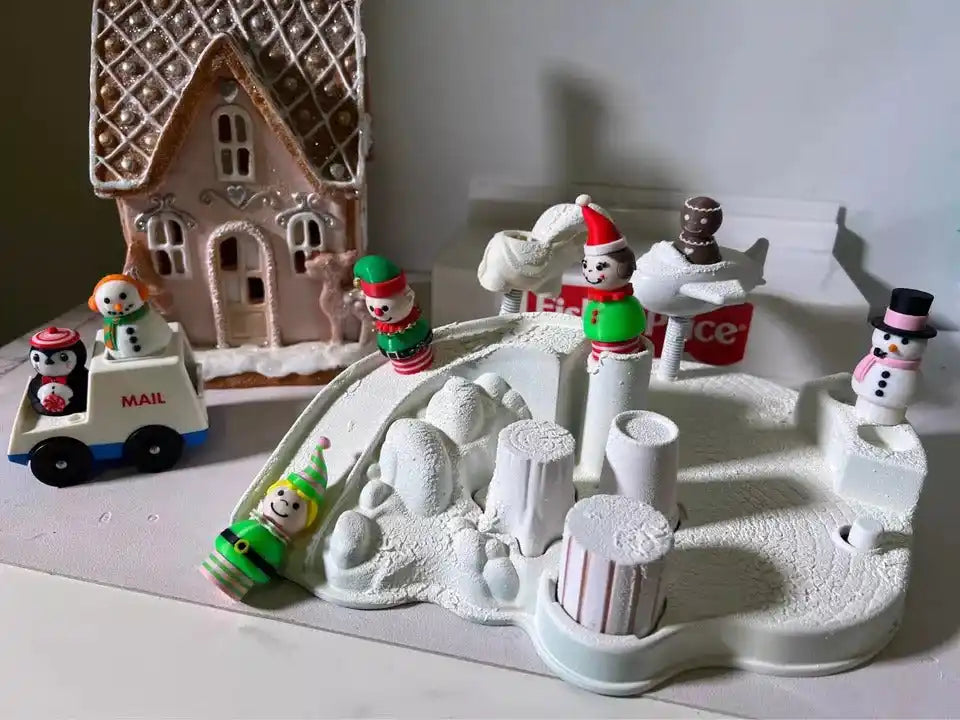 Holiday elf and snowman figurines on white snowy base with small mailbox sign
