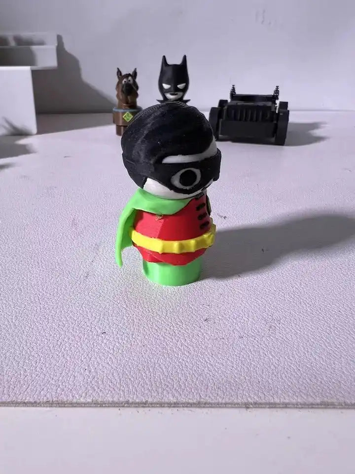 Robin character plush figure with black hood, white eye mask, green cape and red tunic.