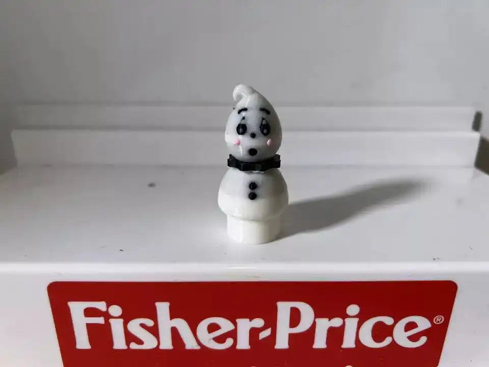 White ghost figurine front view with black dot eyes and mouth