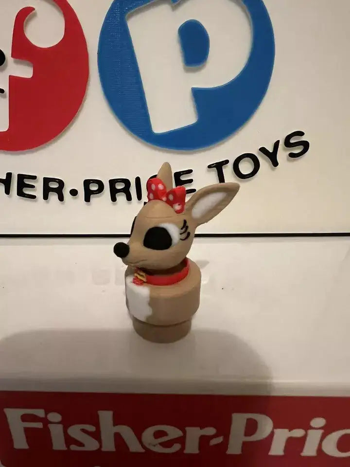 Small animal holiday figurine with red scarf and polka-dot bow, side view.