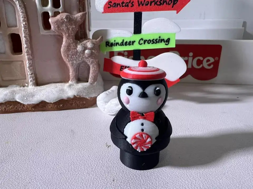 Peppermint penguin holiday figurine with red bow tie and peppermint candy ornament