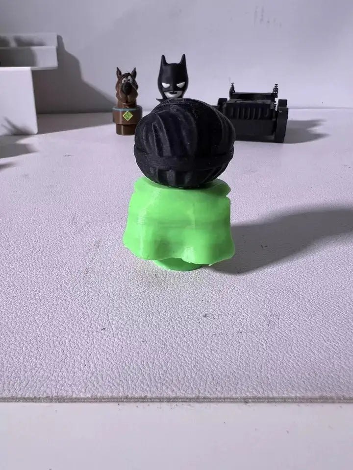 Robin character plush figure back view, black hood with green outfit.