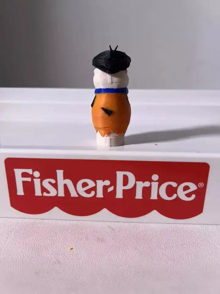 Fred Flintstone toy figure facing right, orange tunic with blue vest