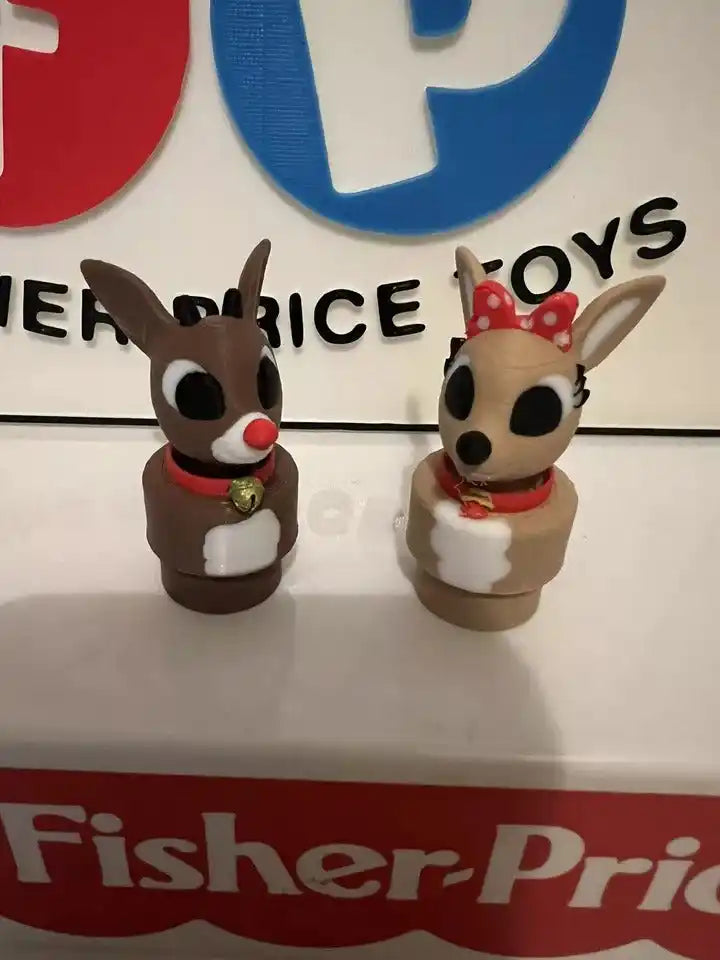 Pair of small animal holiday figurines with red scarves and polka-dot bows, standing.