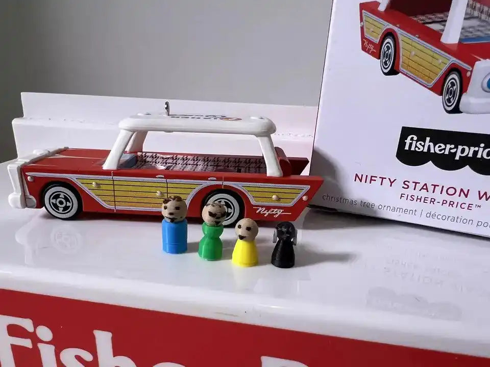 Mini station wagon ornament in red, yellow, and white with four tiny passenger figures