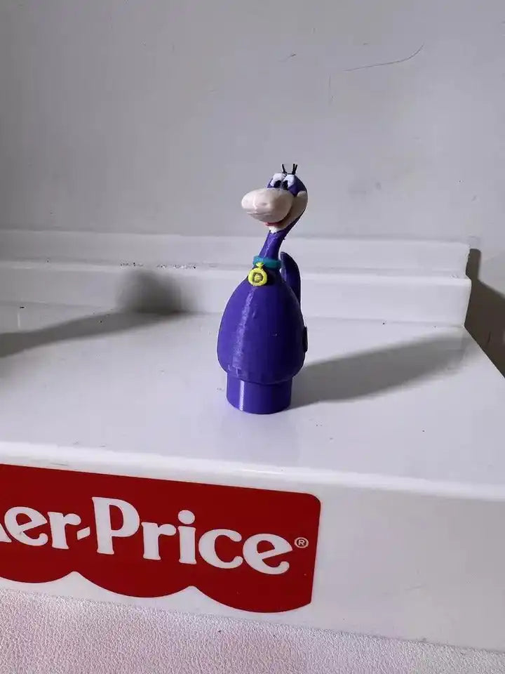 Purple dinosaur figurine with white belly, yellow emblem, and blue head