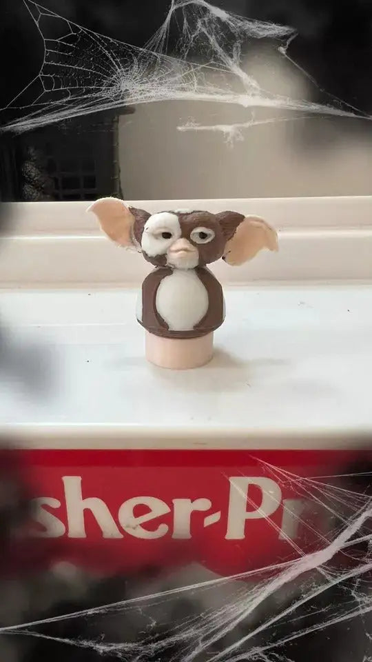 A custom Fisher-Price Little People "Gizmo" figure, brown and white with large ears, standing in a Halloween diorama.
