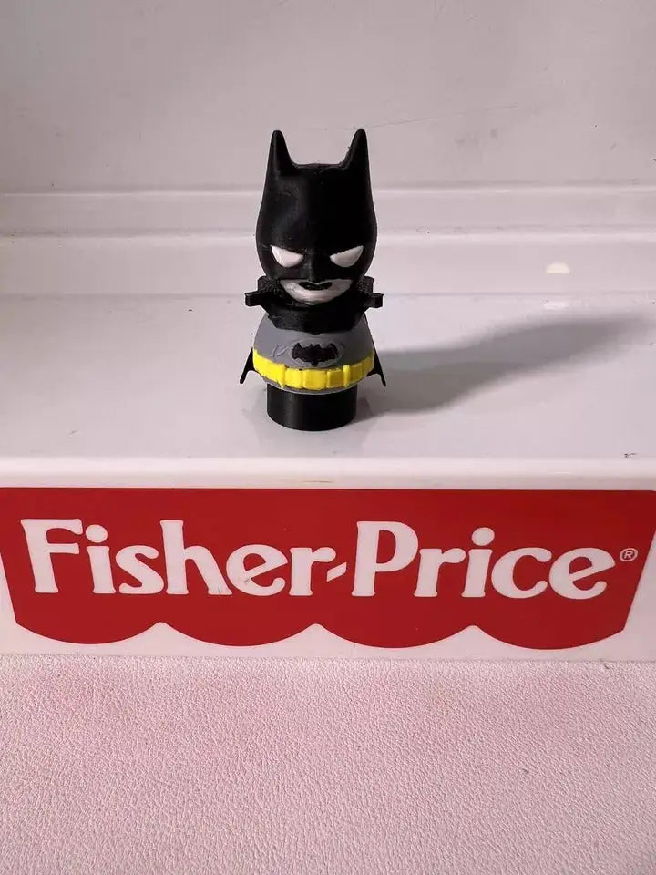 Batman mini figure, black suit with yellow belt, front view on base