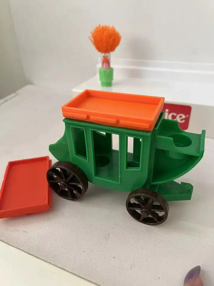 Fisher Price stagecoach wagon with installed orange roof and a spare orange panel