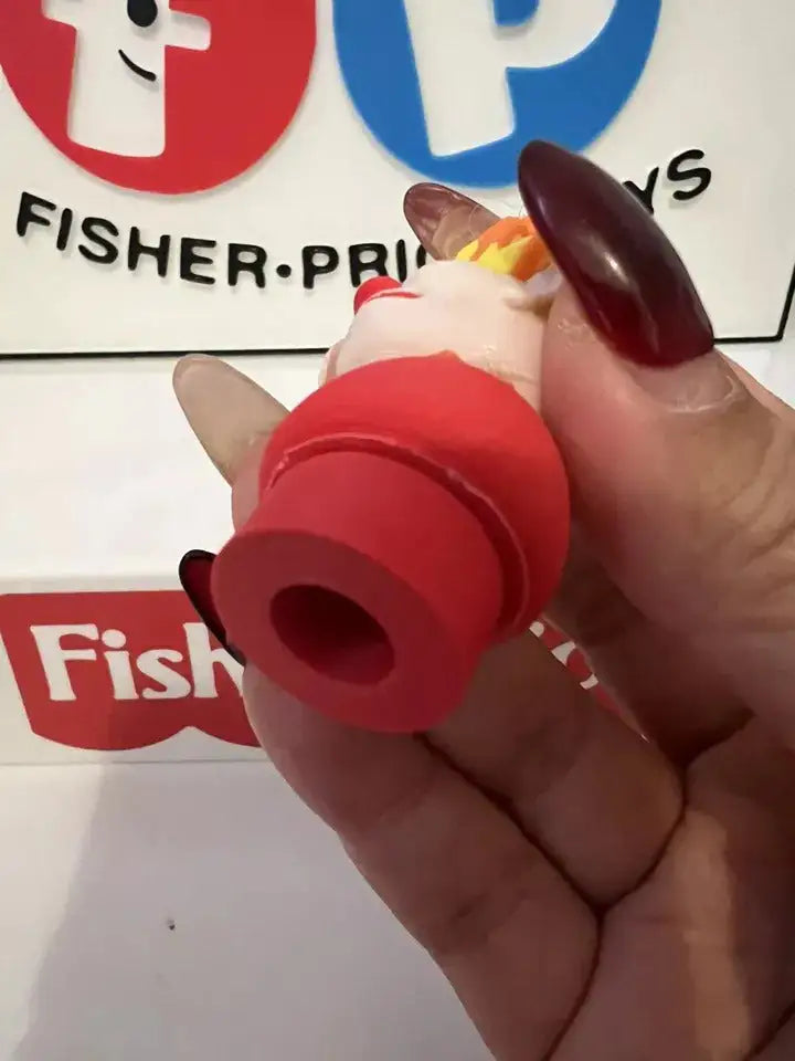 Close-up of red holiday figure base held in hand