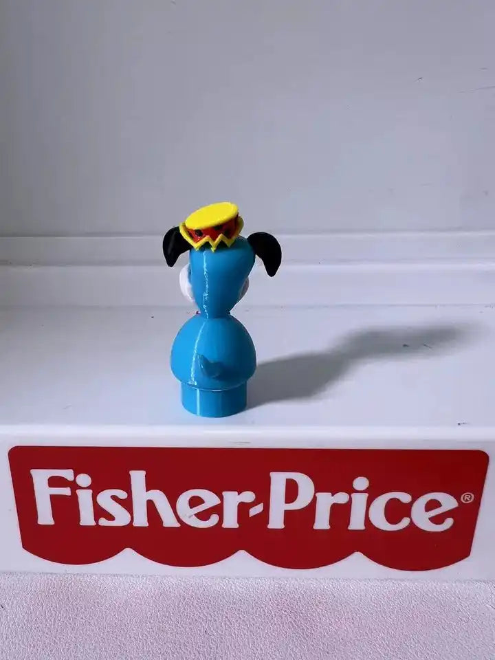 Huckleberry Hound blue figurine with yellow hat, black ears, red bow, white muzzle
