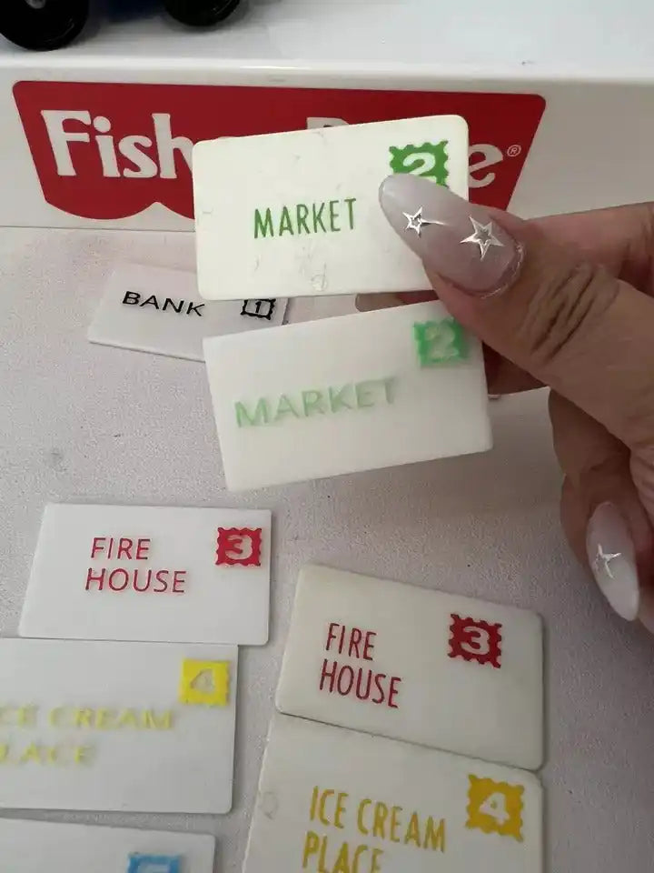 Hand placing a Market replacement mail card over other Fisher-Price address cards