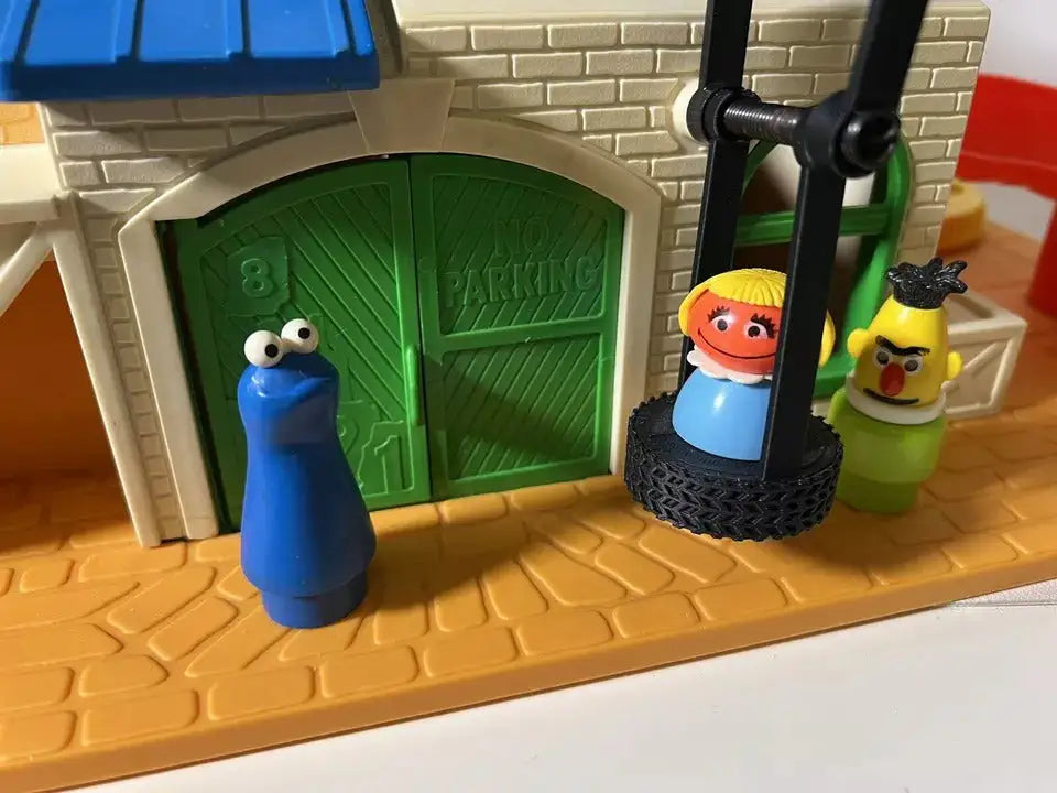 The custom Fisher-Price Sesame Street Clubhouse replacement tire swing features a figure on a black tire, with Cookie Monster and Bert beside it.