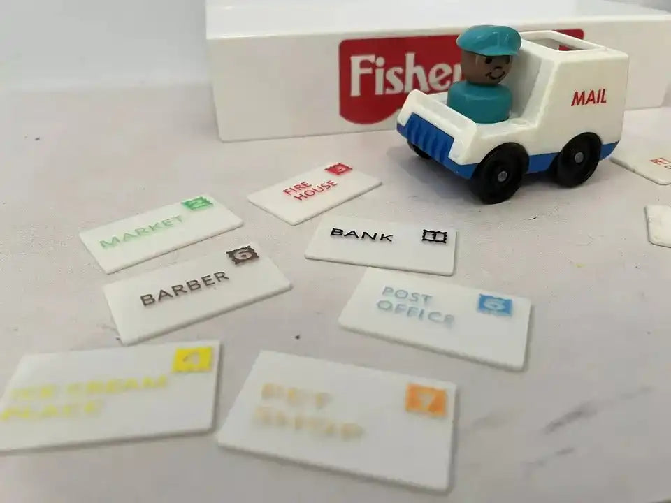 Fisher-Price mail truck beside replacement address cards including Barber, Post Office, Market, and Fire House