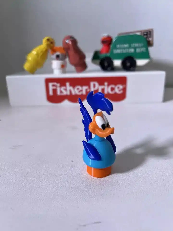 A blue and orange custom 3D-printed Road Runner Little People figure stands with vintage Fisher-Price toys in the background.