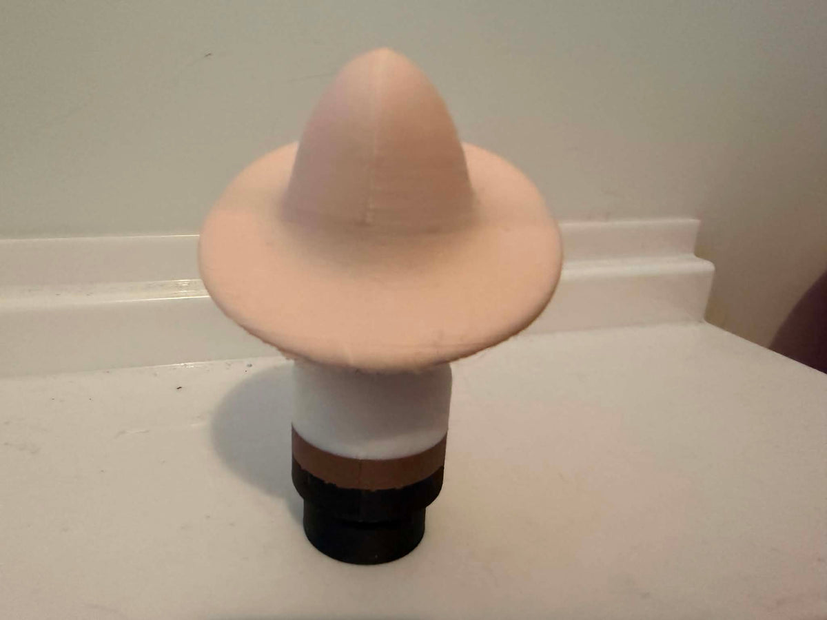 Skeleton man figurine back view with tall beige hat