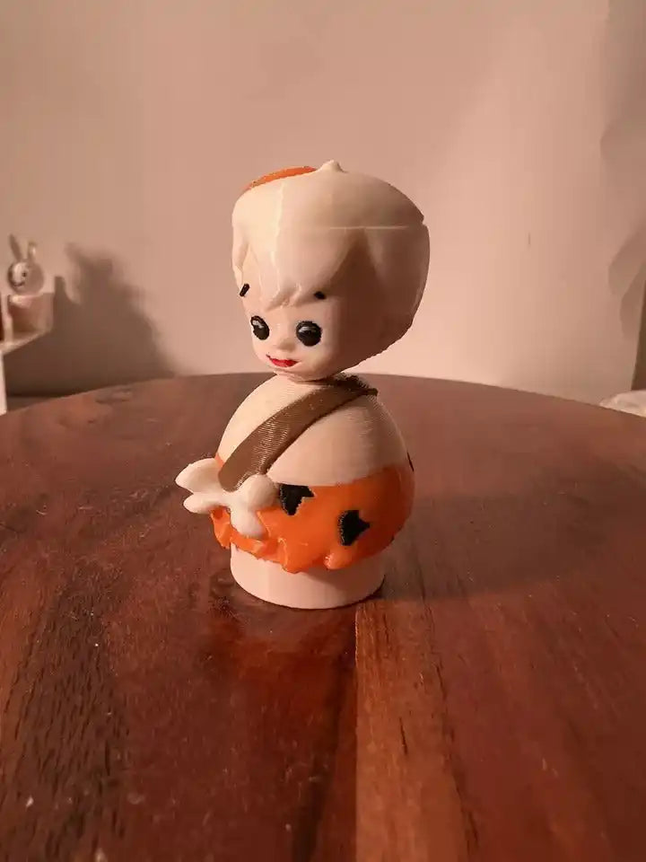 Bam Bam collectible figure in white with orange-and-black spots, holding orange club