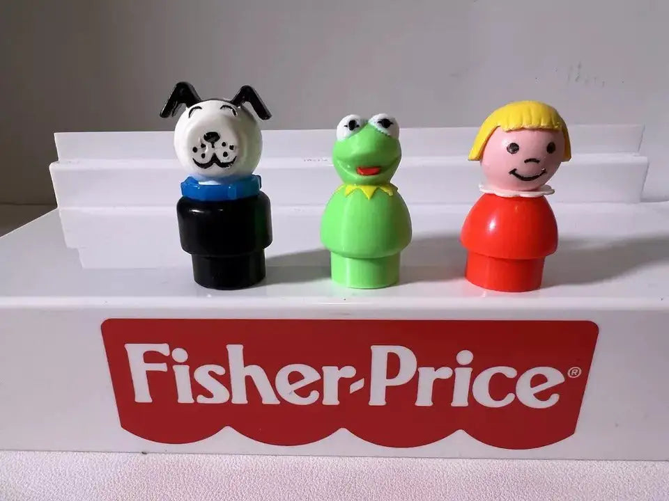A custom 3D-printed Muppets Kermit the Frog Little People figure stands with a dog and a girl on a Fisher-Price display.