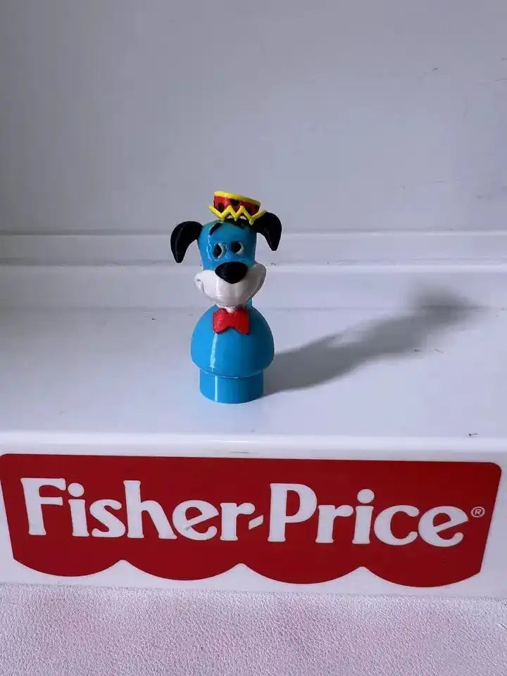 Huckleberry Hound blue figurine with yellow hat, black ears, red scarf, front view