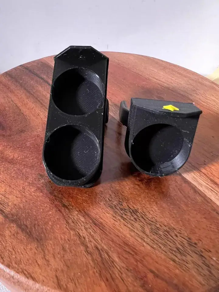 Two black saddle stand pieces with yellow star accents and circular cutouts on wood