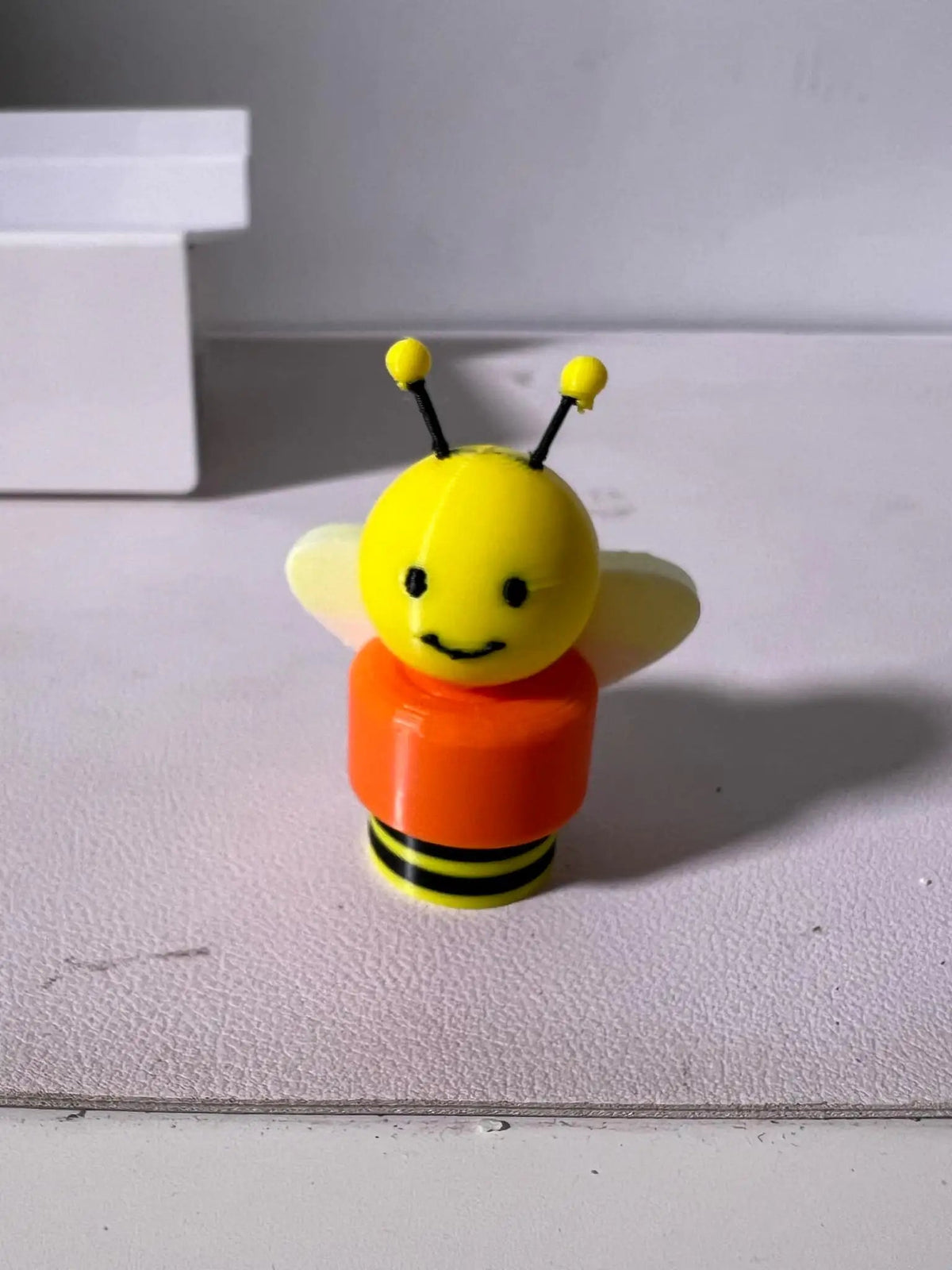 Cheerio Bee Cereal Buddies toy bee figure with yellow head and orange striped body