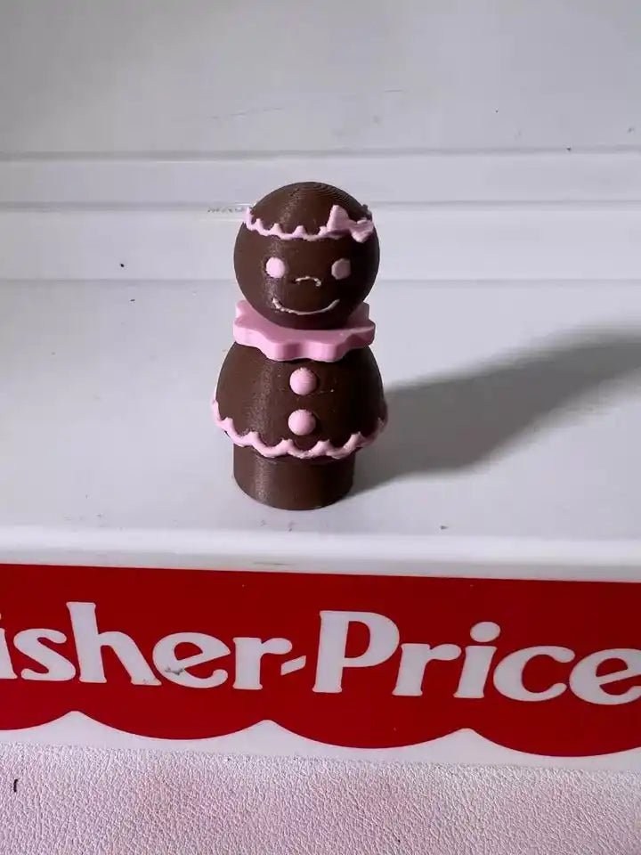Pink-iced gingerbread pals figurine with two stacked cookie characters