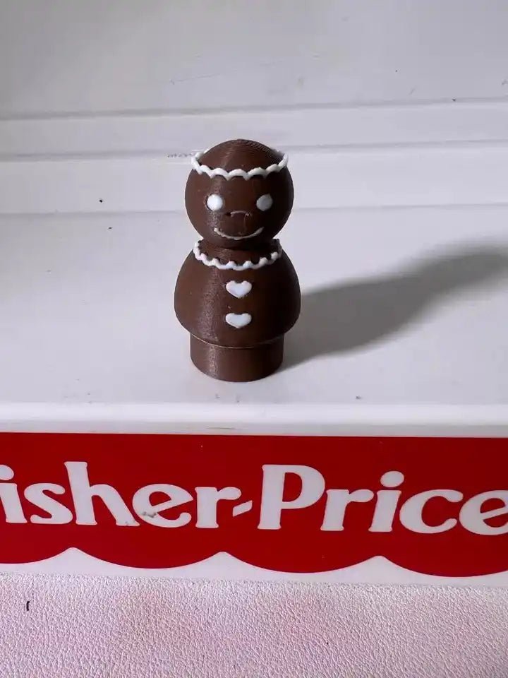 White-iced gingerbread pals figurine with two stacked cookie characters