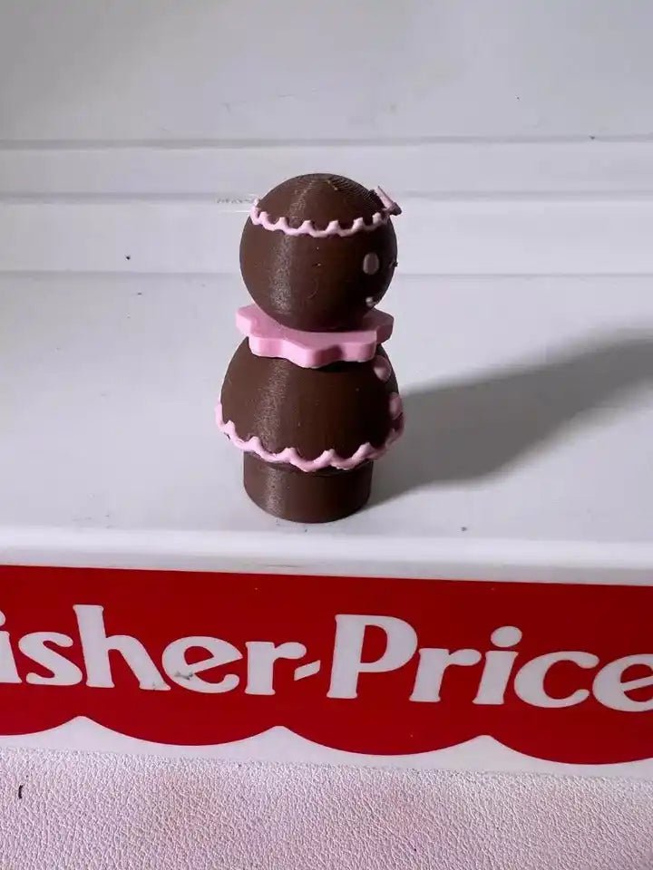 Pink-iced gingerbread pals figurine showing two stacked cookie characters